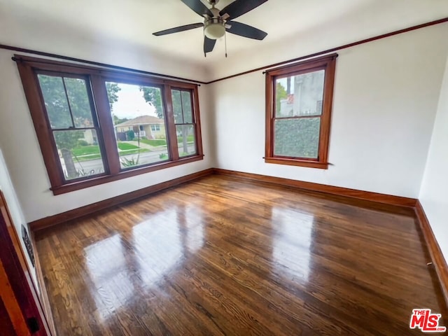 unfurnished room with dark hardwood / wood-style floors and ceiling fan