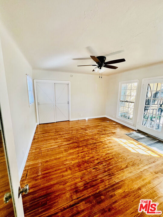 unfurnished room featuring hardwood / wood-style flooring and ceiling fan