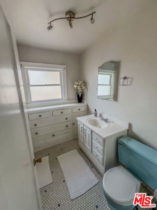 bathroom featuring vanity, toilet, and tile patterned flooring