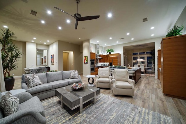 living room featuring ceiling fan and light hardwood / wood-style flooring