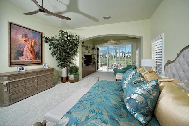 bedroom featuring light colored carpet and ceiling fan with notable chandelier