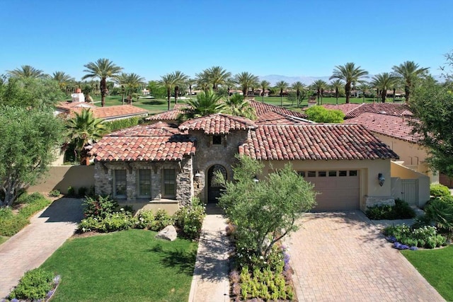 view of front of home with a garage and a front yard