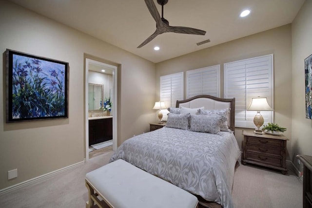 carpeted bedroom featuring ensuite bathroom and ceiling fan