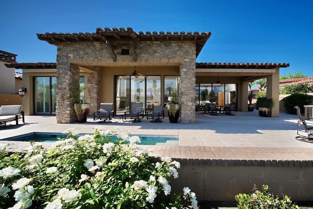 back of house with a patio and ceiling fan