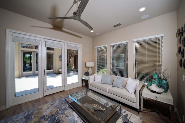 living room featuring ceiling fan and wood-type flooring