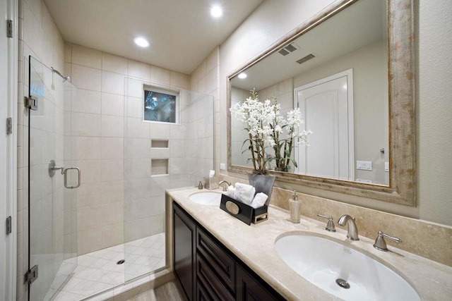 bathroom featuring vanity and an enclosed shower