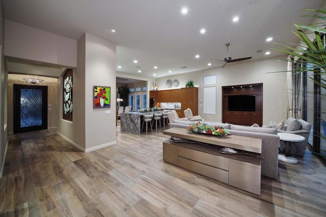 living room with light wood-type flooring and ceiling fan