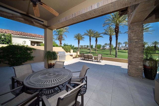 view of patio / terrace featuring a grill, ceiling fan, and exterior kitchen