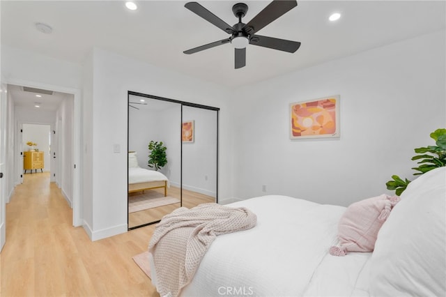 bedroom with ceiling fan, a closet, and light wood-type flooring