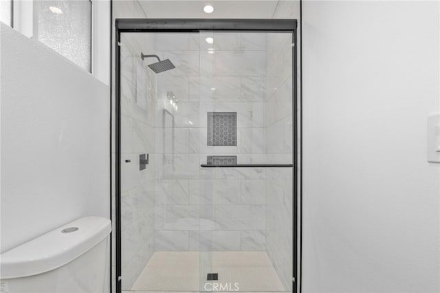 bathroom featuring toilet and walk in shower