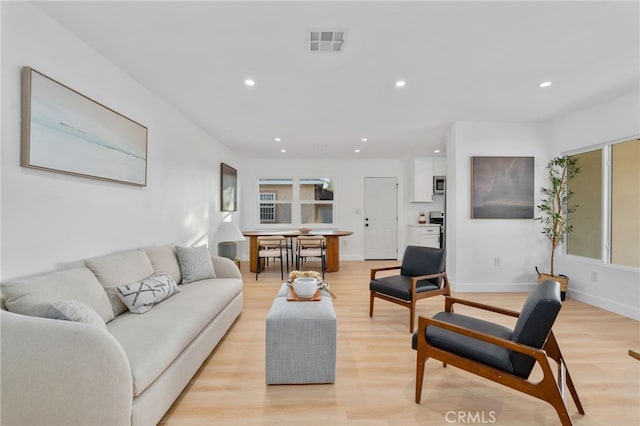 living room with light hardwood / wood-style flooring