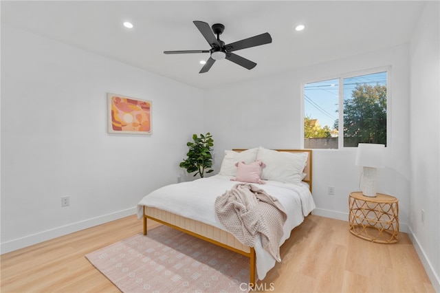 bedroom with ceiling fan and light hardwood / wood-style floors