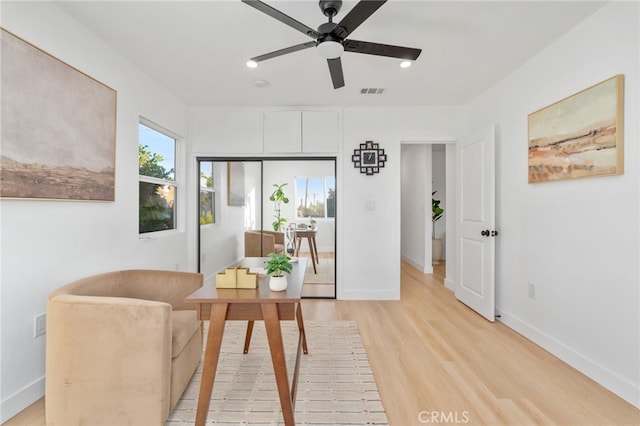 sitting room featuring ceiling fan and light wood-type flooring