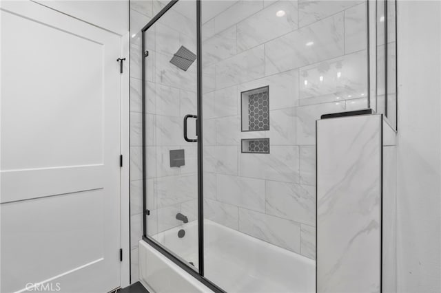 bathroom featuring shower / bath combination with glass door