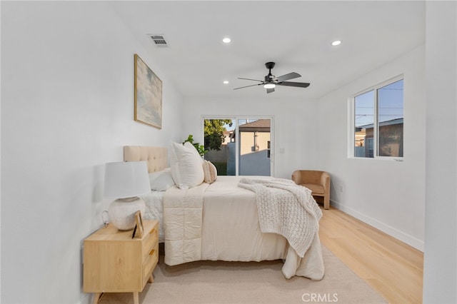 bedroom with ceiling fan, access to exterior, and wood-type flooring