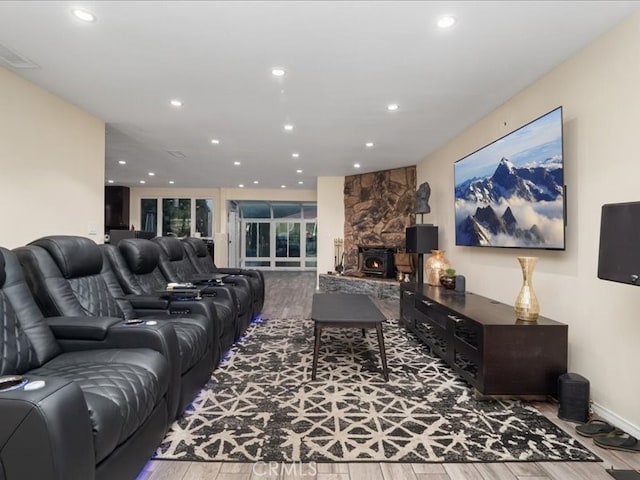 living room featuring hardwood / wood-style floors and a wood stove