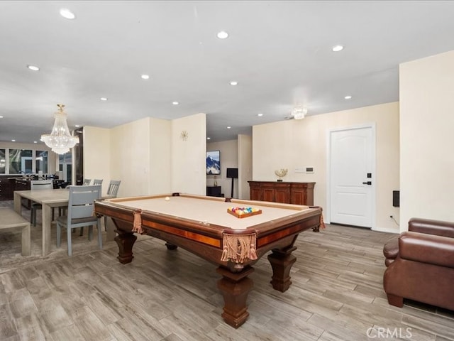 playroom with a notable chandelier, light hardwood / wood-style flooring, and pool table