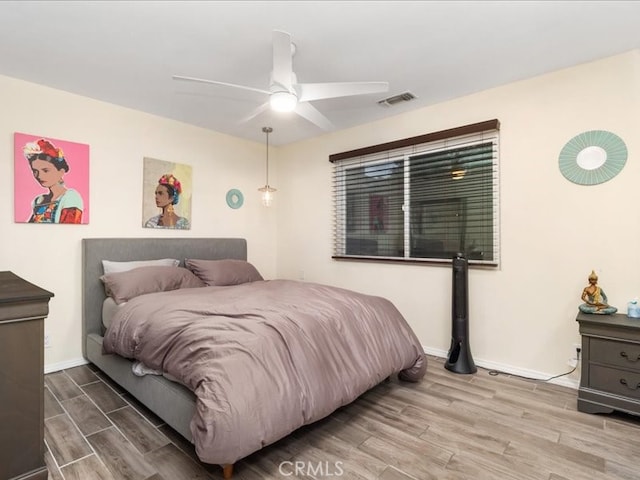 bedroom with ceiling fan and hardwood / wood-style flooring