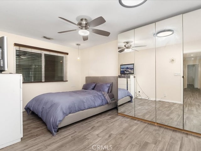 bedroom with hardwood / wood-style floors and ceiling fan