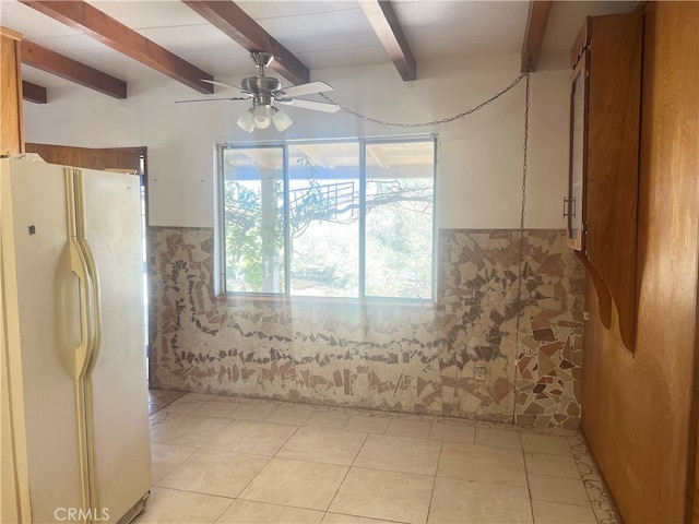 interior space featuring beam ceiling, tile patterned flooring, and ceiling fan