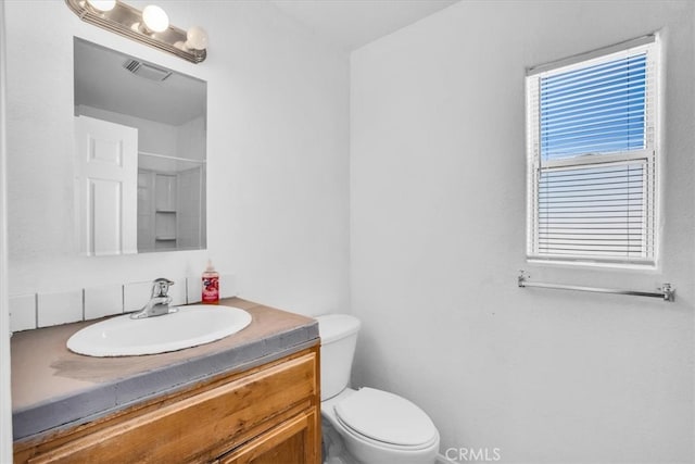 bathroom with vanity and toilet