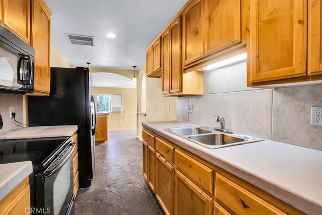 kitchen with black appliances, sink, decorative backsplash, and hanging light fixtures