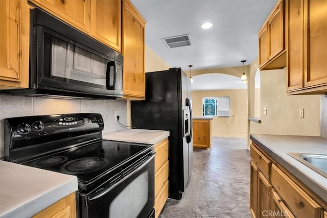 kitchen featuring black appliances, decorative light fixtures, and decorative backsplash