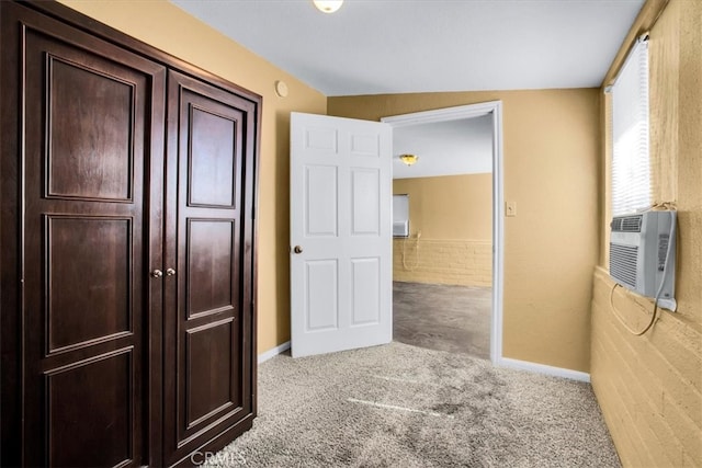 hall with cooling unit and light colored carpet