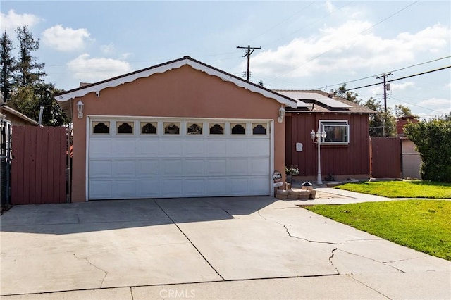 ranch-style house featuring a garage, a front yard, and solar panels