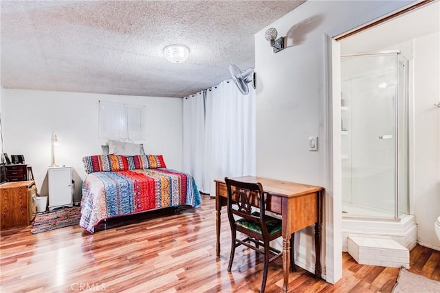 bedroom featuring a textured ceiling and light wood-type flooring