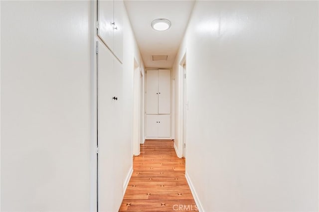 corridor with light hardwood / wood-style flooring