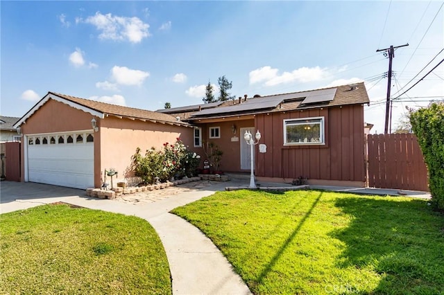 ranch-style house with a garage, a front lawn, and solar panels