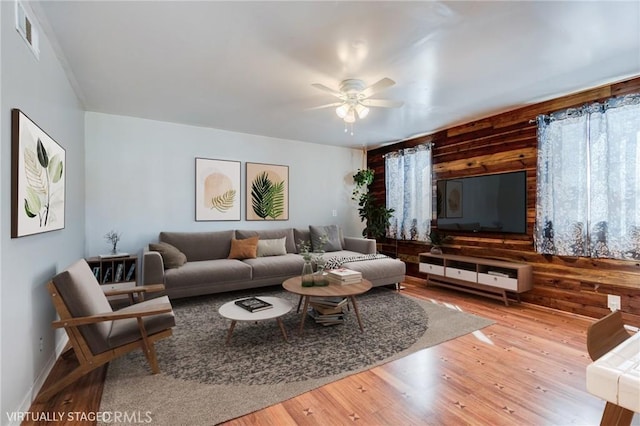 living room featuring ceiling fan, plenty of natural light, and hardwood / wood-style floors