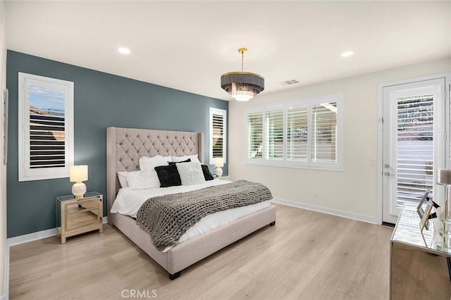 bedroom with light hardwood / wood-style flooring and multiple windows