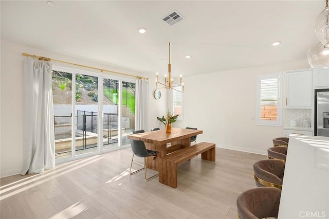 dining room featuring light hardwood / wood-style floors and an inviting chandelier