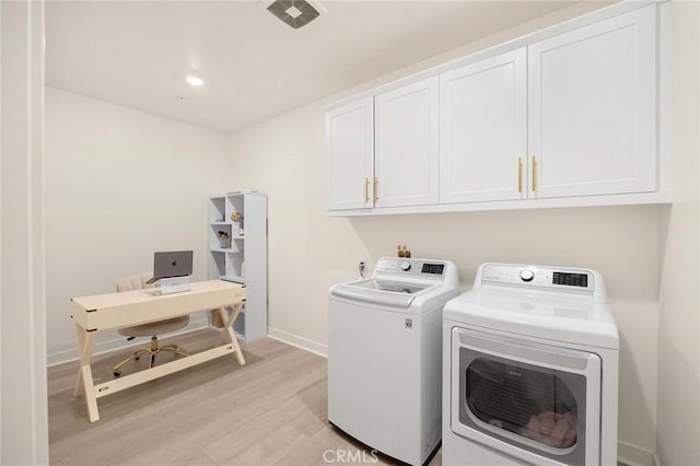 laundry area featuring cabinets, independent washer and dryer, and light wood-type flooring