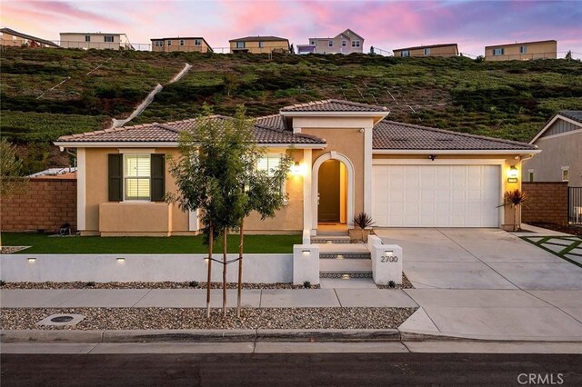 mediterranean / spanish house with a garage