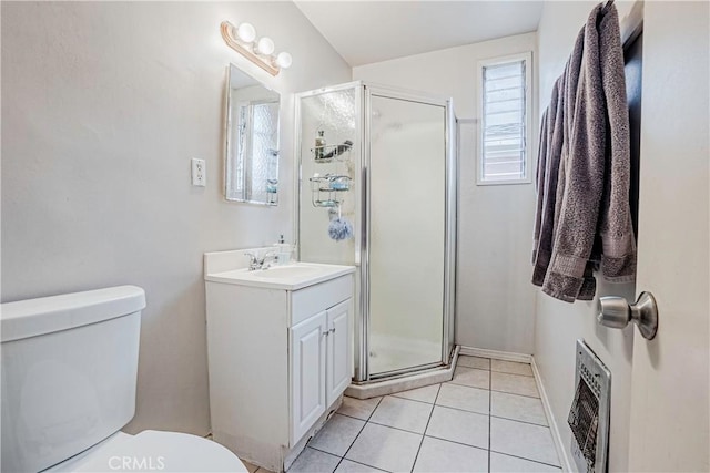 bathroom with tile patterned flooring, heating unit, toilet, and a shower with door