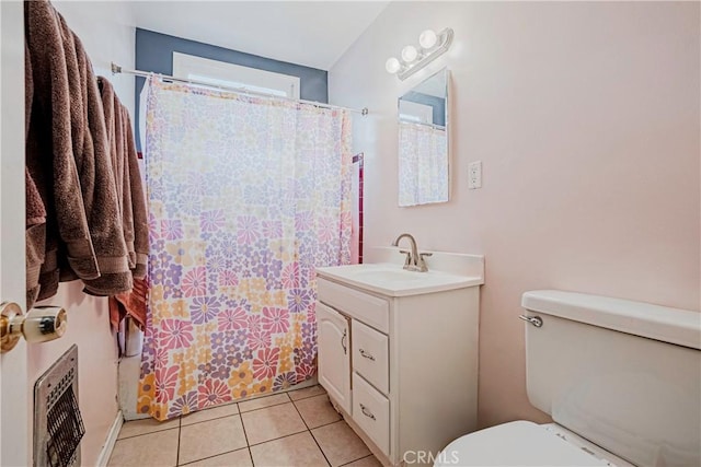 bathroom featuring tile patterned floors, vanity, a shower with shower curtain, and toilet