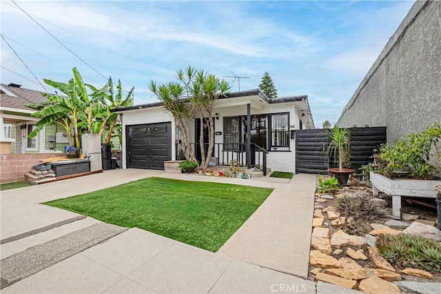 view of front of house with a garage and a front lawn