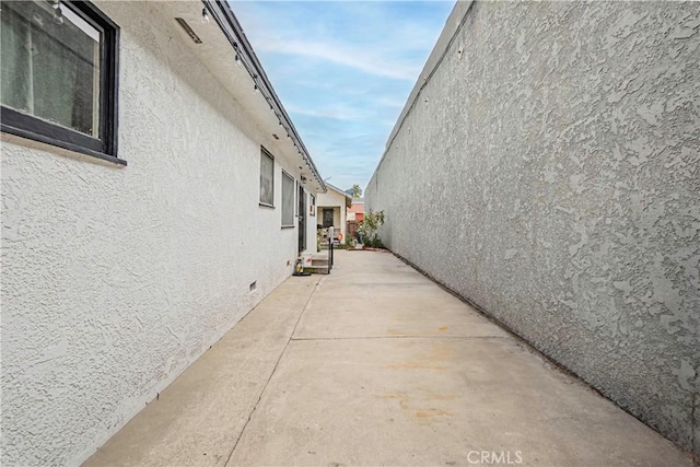 view of side of home with a patio