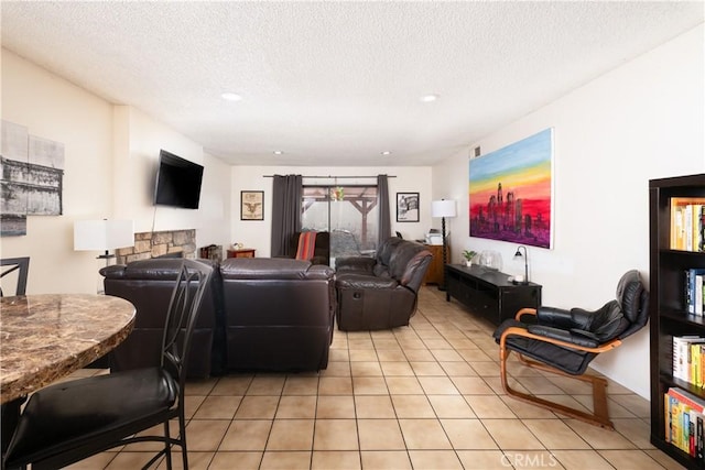 tiled living room featuring a textured ceiling