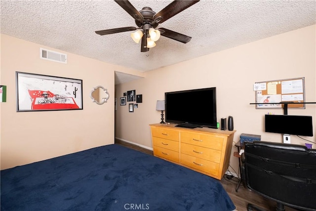 carpeted bedroom featuring a textured ceiling and ceiling fan