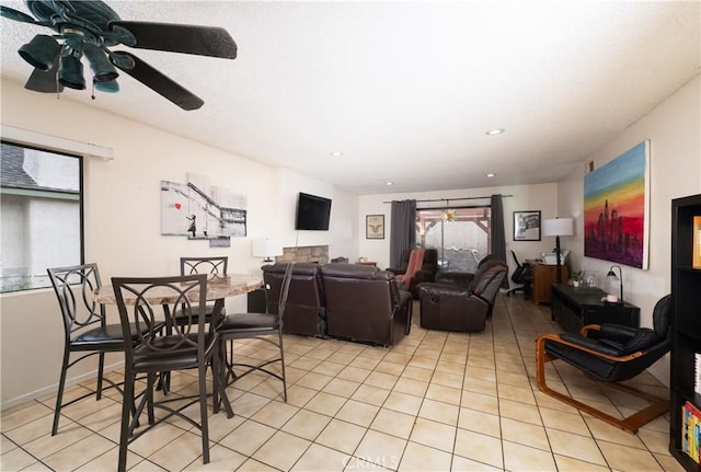 dining space featuring ceiling fan and light tile patterned floors