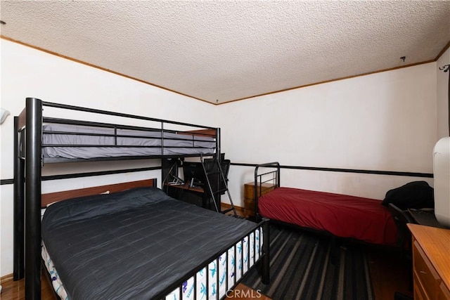 bedroom featuring hardwood / wood-style floors and a textured ceiling