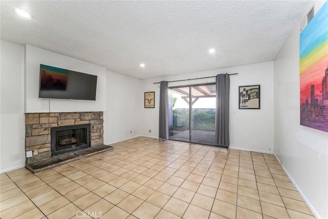 unfurnished living room with recessed lighting, baseboards, a stone fireplace, and a textured ceiling