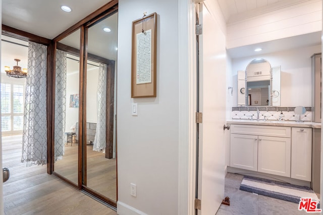 hallway featuring light hardwood / wood-style floors and sink