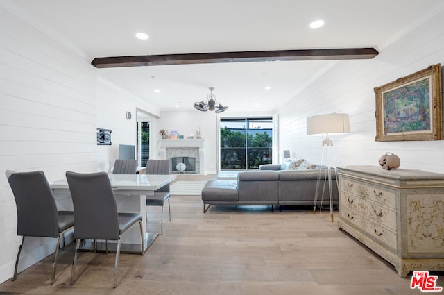 interior space with beamed ceiling, crown molding, and light wood-type flooring