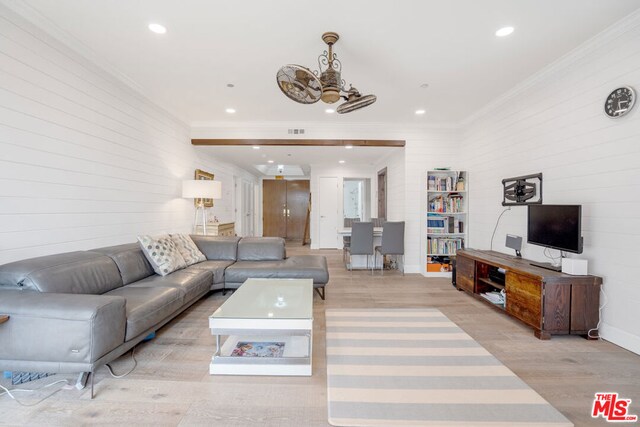 living room featuring ornamental molding and light wood-type flooring