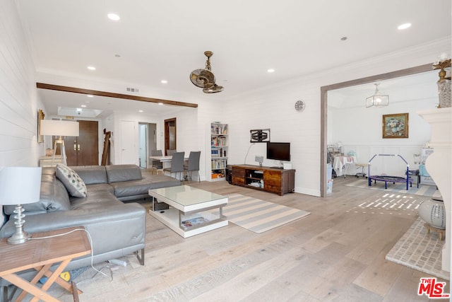 living room with light hardwood / wood-style floors and crown molding